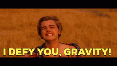 A Man Is Crying In A Field With The Words `` I Defy You , Gravity ! '' Behind Him . GIF