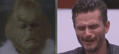 A Man Is Crying Next To A Picture Of Grinch . GIF