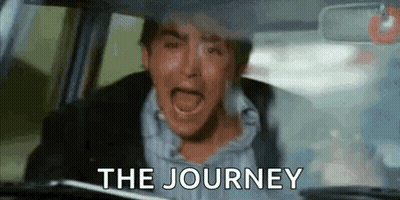 A Man Is Crying While Driving A Car With The Words `` The Journey '' Written On The Windshield . GIF