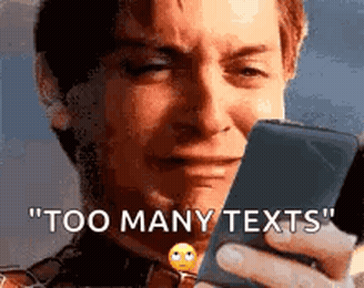 A Man Is Crying While Holding A Cell Phone And Says `` Too Many Texts '' . GIF