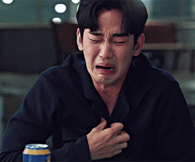 A Man Is Crying While Holding His Chest And A Can Of Beer Is In Front Of Him GIF