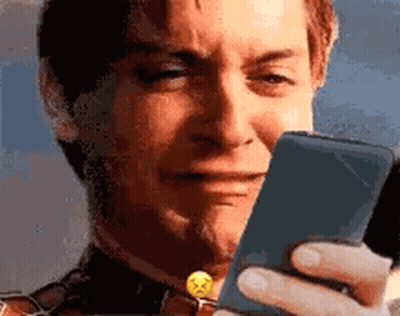 A Man Is Crying While Looking At His Phone . GIF