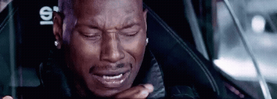 A Man Is Crying While Sitting In A Car Seat . GIF