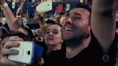 A Man Is Crying While Taking A Picture Of Himself With A Samsung Phone GIF