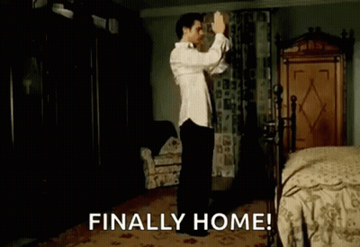 A Man Is Dancing In A Bedroom With The Words `` Finally Home '' Written Above Him . GIF