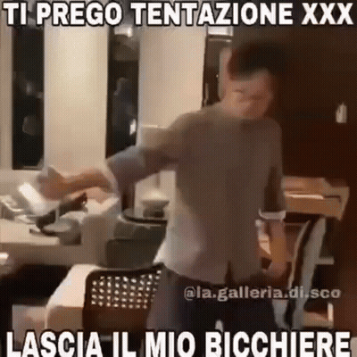 A Man Is Dancing In A Kitchen With A Caption That Says `` Ti Prego Tentazione Xxx La Scia Il Mio Bicchiere '' . GIF