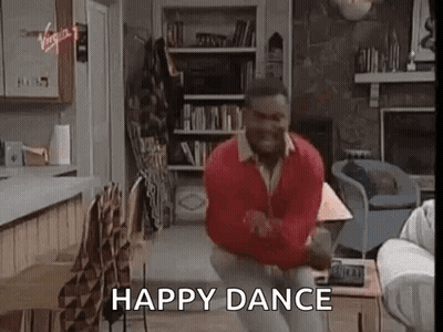 A Man Is Dancing In A Living Room In Front Of A Fireplace . GIF