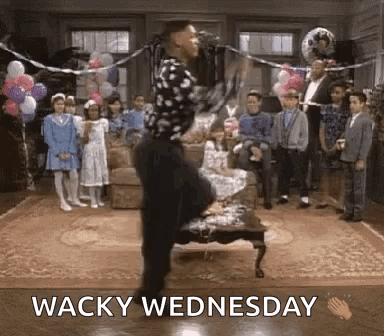 A Man Is Dancing In A Living Room With Balloons And The Words Wacky Wednesday Below Him . GIF
