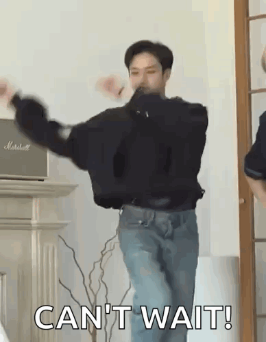 A Man Is Dancing In A Living Room With The Words `` Can 'T Wait '' Written On The Bottom . GIF