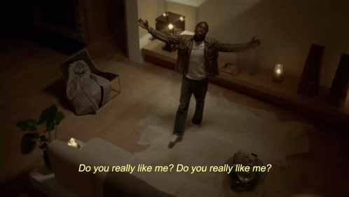 A Man Is Dancing In A Living Room With The Words Do You Really Like Me Behind Him GIF
