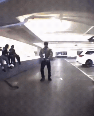 A Man Is Dancing In A Parking Garage GIF