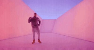 A Man Is Dancing In A Purple Room . GIF