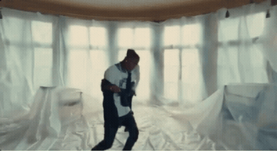 A Man Is Dancing In A Room Covered In White Cloth GIF