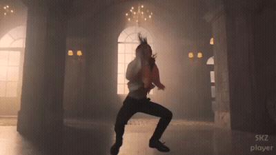A Man Is Dancing In A Room With The Words Skz Player Visible GIF