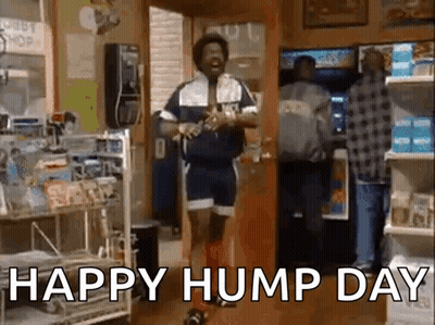 A Man Is Dancing In A Store With The Words `` Happy Hump Day '' Written On The Screen . GIF