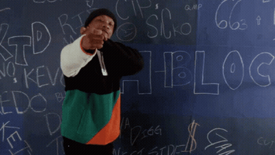 A Man Is Dancing In Front Of A Blackboard That Says " Blocc " GIF