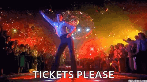 A Man Is Dancing In Front Of A Crowd At A Disco And The Words `` Tickets Please '' Are Visible . GIF