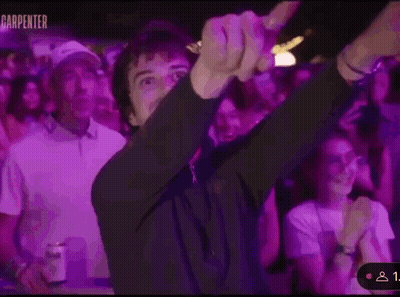 A Man Is Dancing In Front Of A Crowd Of People At A Party . GIF