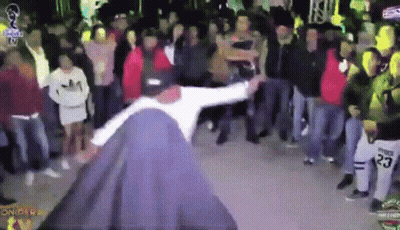 A Man Is Dancing In Front Of A Crowd With The Number 23 On His Shirt GIF