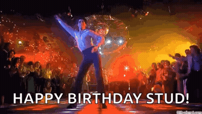 A Man Is Dancing In Front Of A Disco Ball In A Nightclub . GIF