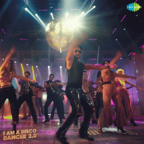 A Man Is Dancing In Front Of A Disco Ball With The Words " I Am A Disco Dancer 2.0 " On The Bottom GIF