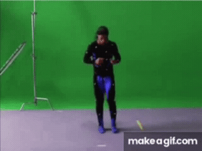 A Man Is Dancing In Front Of A Green Screen .. GIF
