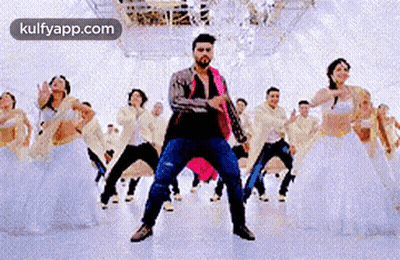 A Man Is Dancing In Front Of A Group Of Dancers In A Dance Studio . GIF