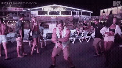 A Man Is Dancing In Front Of A Group Of People At A Party . GIF