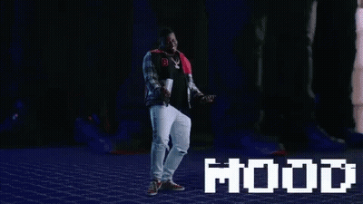 A Man Is Dancing In Front Of A Screen That Says Mood GIF