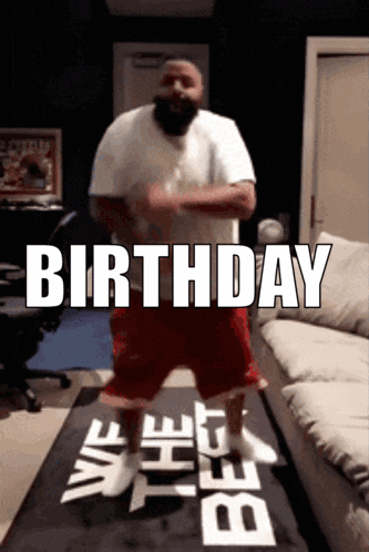 A Man Is Dancing In Front Of A Sign That Says Birthday On It GIF