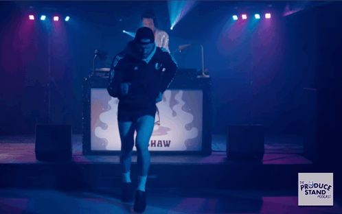 A Man Is Dancing In Front Of A Sign That Says " Eva W " GIF