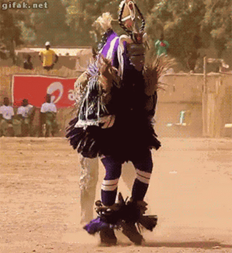 A Man Is Dancing In Front Of A Sign That Says ' Gifak.net ' On It GIF
