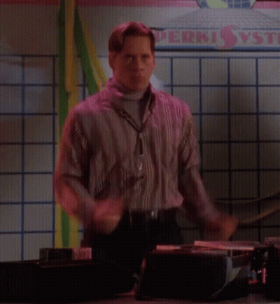 A Man Is Dancing In Front Of A Sign That Says Perki GIF