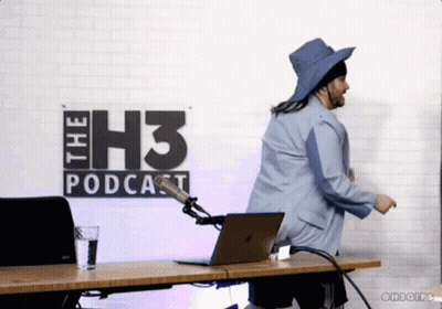 A Man Is Dancing In Front Of A Sign That Says " The H3 Podcast " GIF