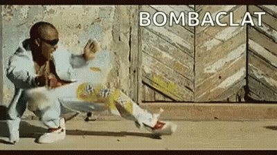 A Man Is Dancing In Front Of A Wooden Door With The Word Bombaclat Written On The Bottom . GIF