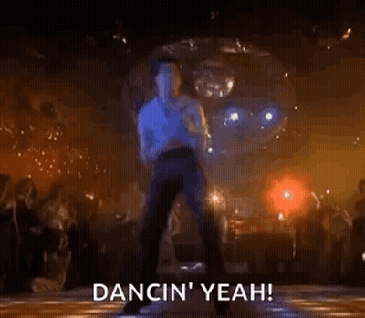 A Man Is Dancing On A Disco Floor In Front Of A Disco Ball In A Club . GIF