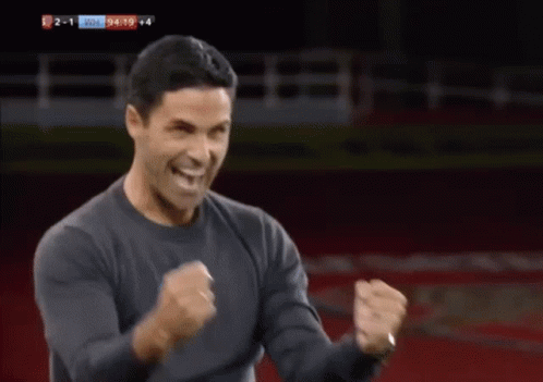 A Man Is Dancing On A Soccer Field In Front Of A Sign That Says Fly Emirates To The Far East GIF