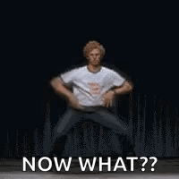 A Man Is Dancing On A Stage And Says `` Now What ? '' . GIF