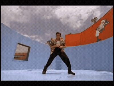 A Man Is Dancing On A Stage In Front Of A Wall With A Baseball Player On It . GIF