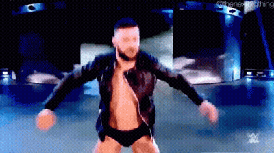 A Man Is Dancing On A Stage With His Arms Outstretched . GIF