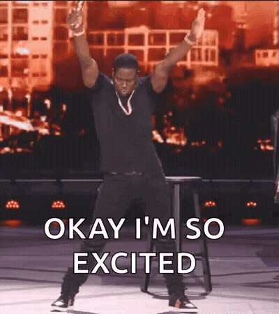 A Man Is Dancing On A Stage With The Words Okay I 'M So Excited Above Him GIF