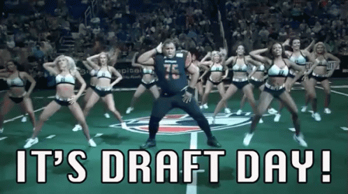 A Man Is Dancing With Cheerleaders On A Football Field With The Words It 'S Draft Day ! GIF