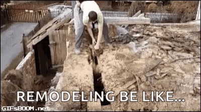 A Man Is Digging A Hole In The Ground With A Shovel In A Dirt Field . GIF