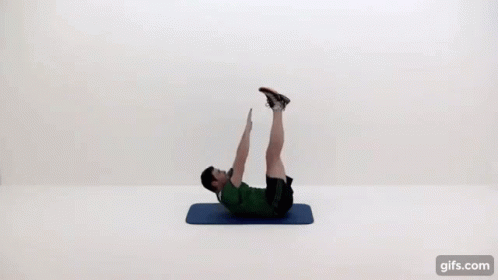 A Man Is Doing A Crunch On A Mat With His Legs Up . GIF