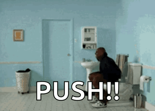 A Man Is Doing A Handstand In A Bathroom With The Word Push Written On The Floor GIF