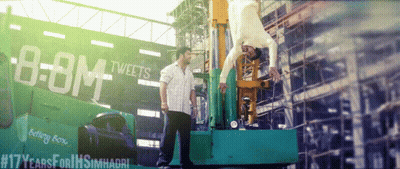 A Man Is Doing A Handstand In Front Of A Billboard That Says " Boom Tweets " GIF
