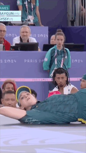 A Man Is Doing A Handstand In Front Of A Crowd At The Paris 2024 Olympics GIF