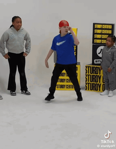 A Man Is Doing A Handstand In Front Of A Jd Sign GIF
