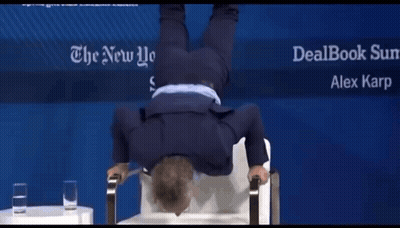 A Man Is Doing A Handstand In Front Of A Sign For The New York Times GIF