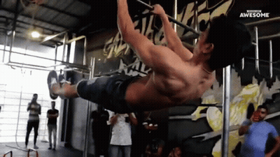 A Man Is Doing A Pull Up On A Bar In A Gym With The Words Awesome Written On The Bottom GIF